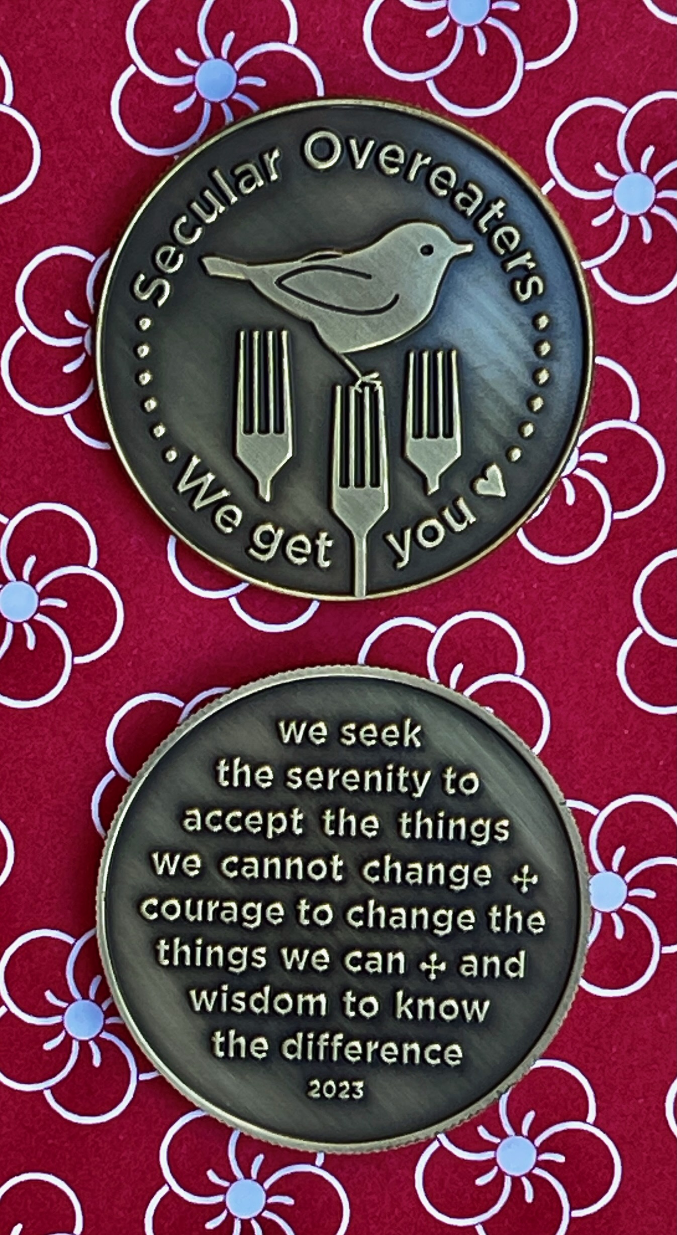 Photo of SO recovery chip includes image of bird with three forks and backside includes Serenity Poem: we seek the serenity to accept the things we cannot change, courage to change the things we can, and the wisdom to know the difference.
